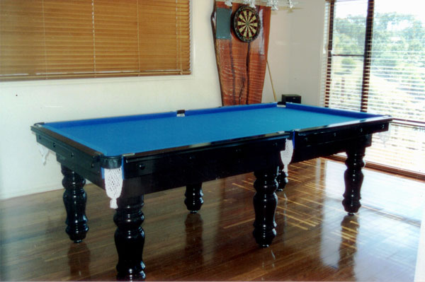 Classic billiard table finished in dark timber with green cloth