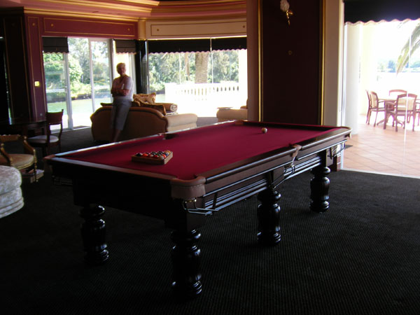 Traditional eight-foot billiard table with brass empire rails